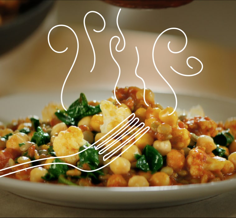 A plate with cooked chickpeas, cauliflower and green leaves, with a drawing of steam rising from it